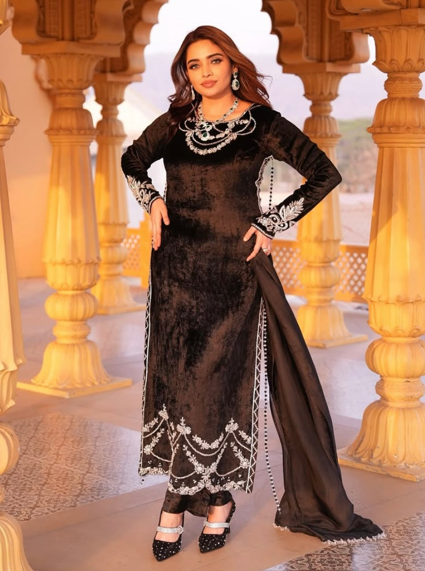 This black velvet dress combines timeless elegance with luxurious texture