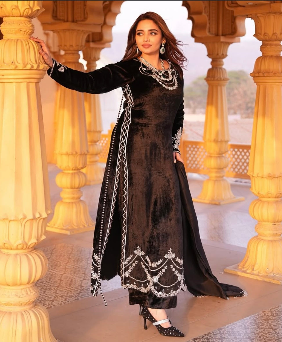 This black velvet dress combines timeless elegance with luxurious texture
