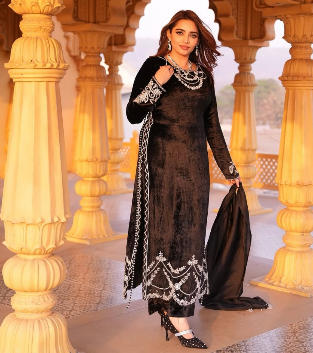 This black velvet dress combines timeless elegance with luxurious texture