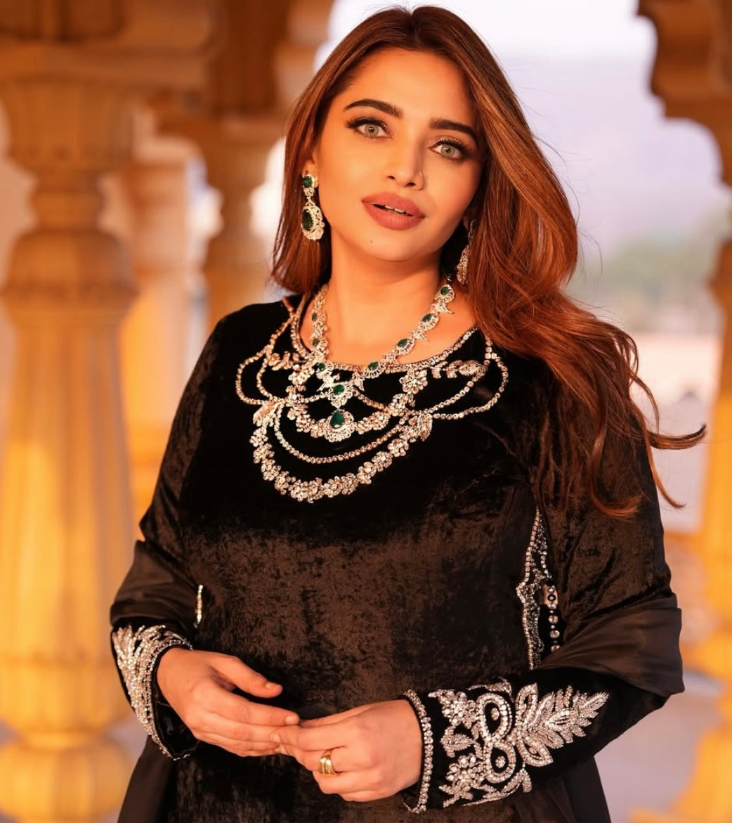 This black velvet dress combines timeless elegance with luxurious texture