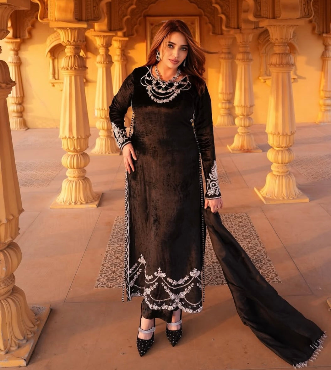 This black velvet dress combines timeless elegance with luxurious texture