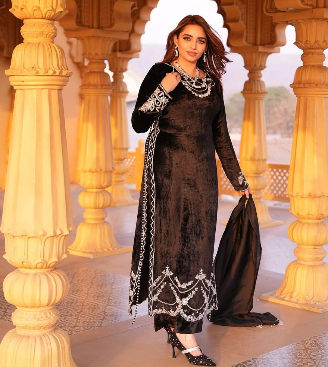 This black velvet dress combines timeless elegance with luxurious texture