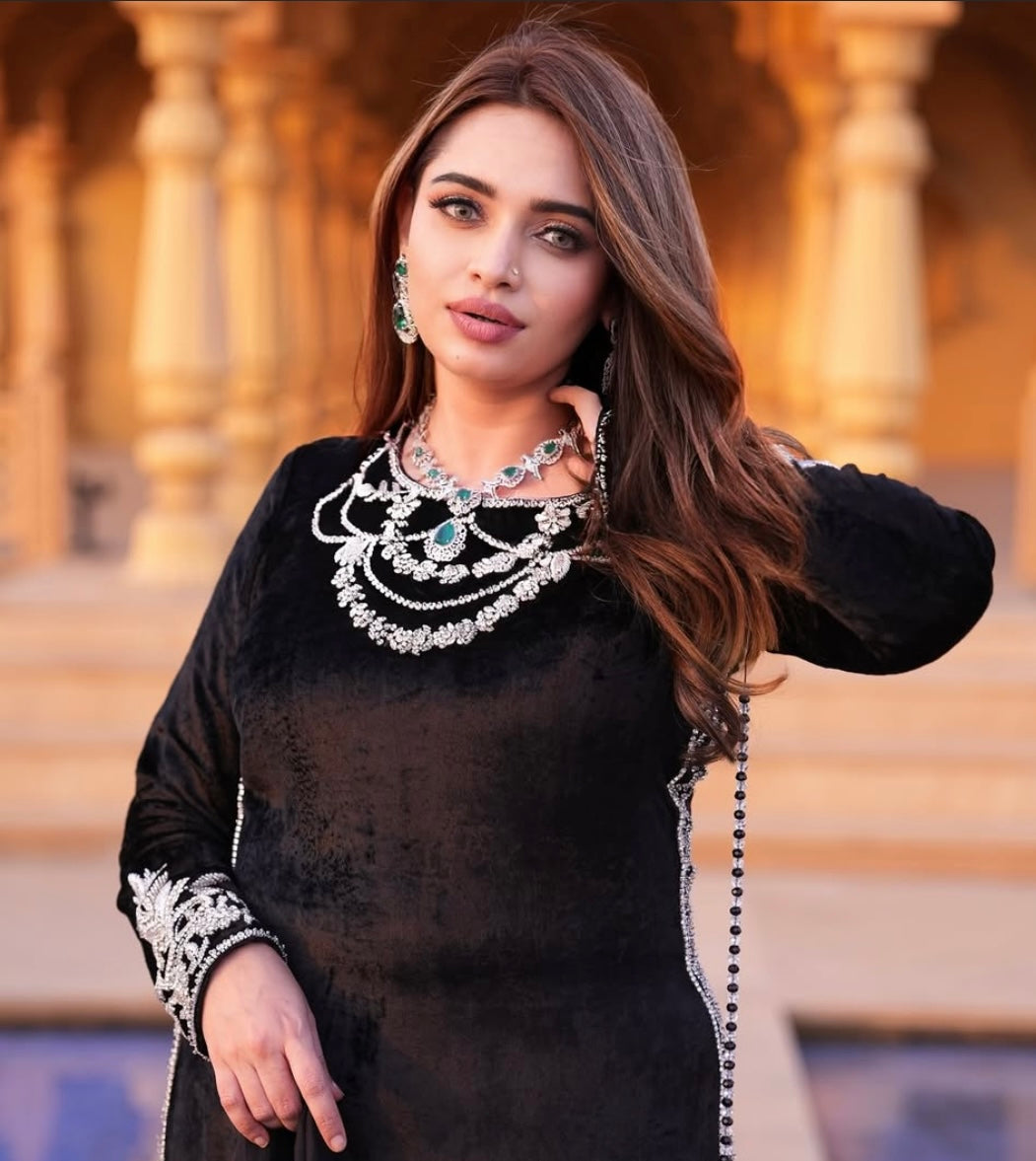 This black velvet dress combines timeless elegance with luxurious texture