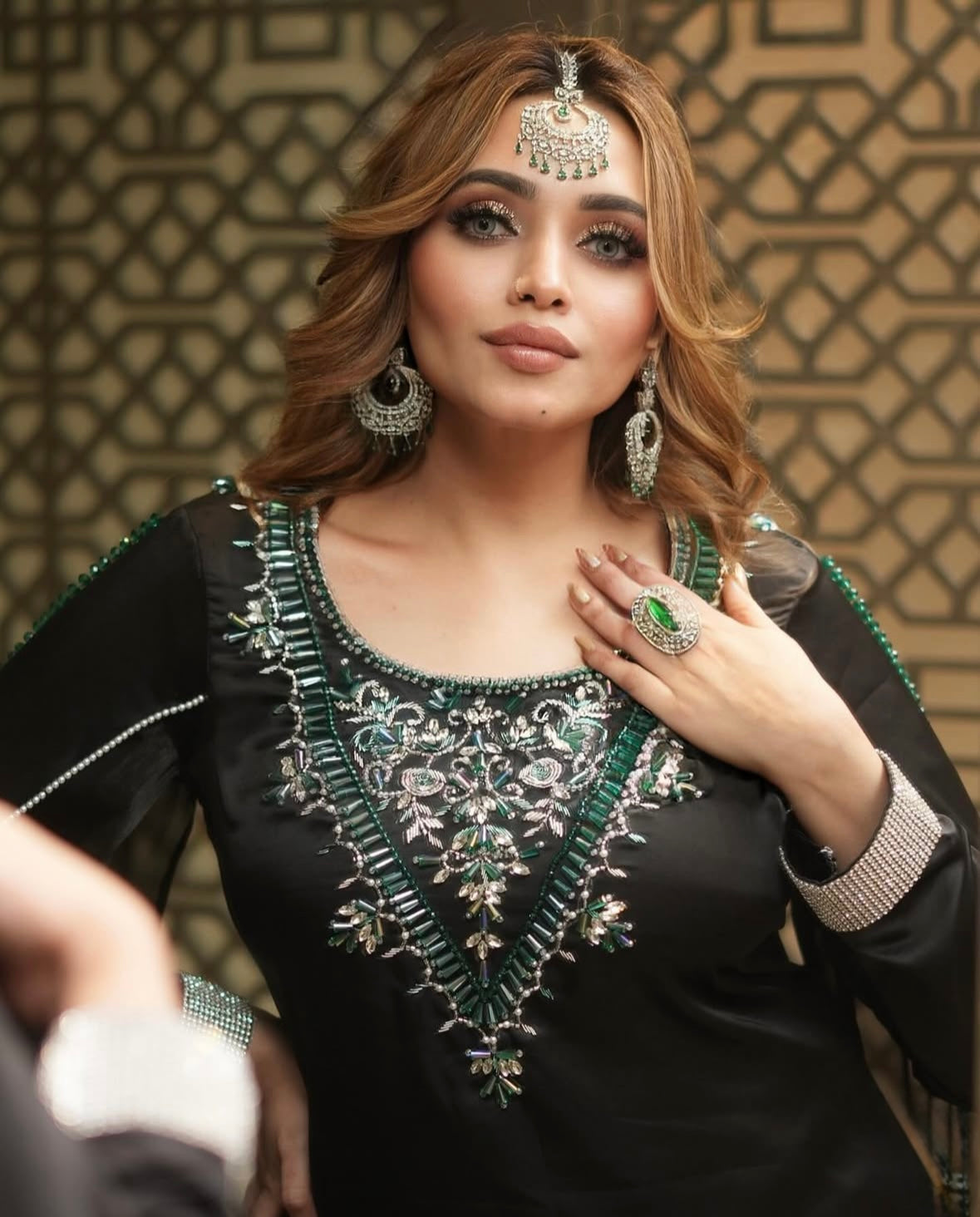Dress features long sleeves and intricate green embroidery