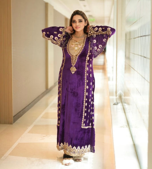 Luxurious velvet purple dress features intricate heavy work